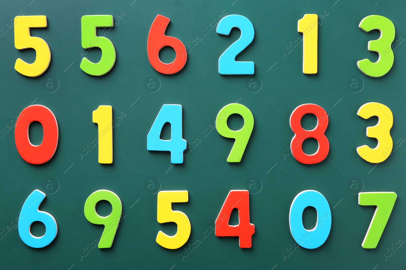 Photo of Colorful numbers on green background, flat lay