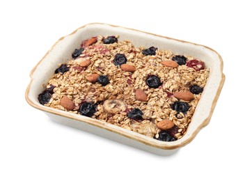Photo of Tasty baked oatmeal with berries and almonds in baking tray isolated on white