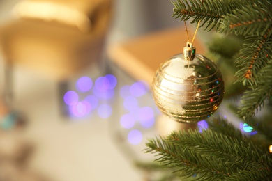 Photo of Shiny decoration on Christmas tree indoors, closeup