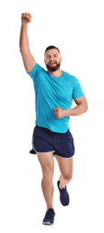 Young happy man in sportswear running on white background