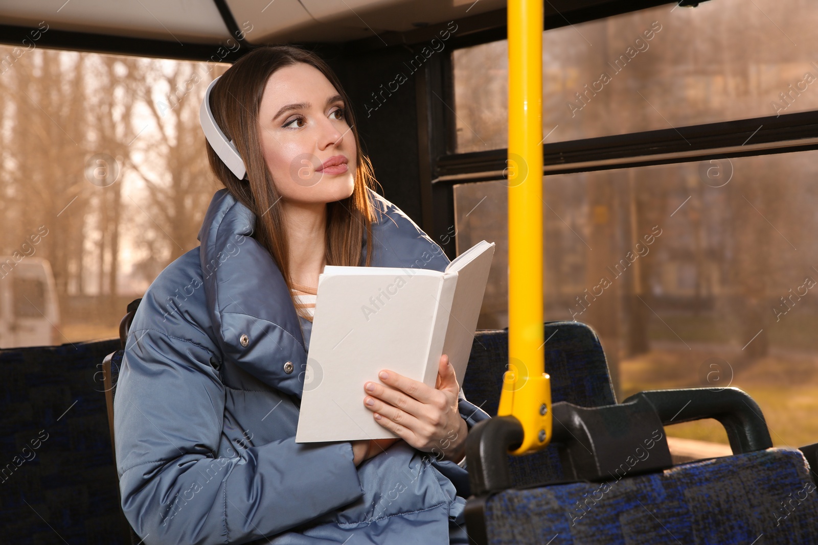 Photo of Woman listening to audiobook in trolley bus