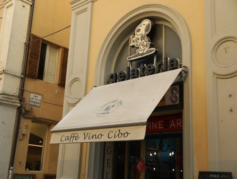 JESI, ITALY - MAY 17, 2022: Entrance of cafe with canopy on city street
