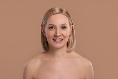 Photo of Beautiful woman with healthy skin on beige background