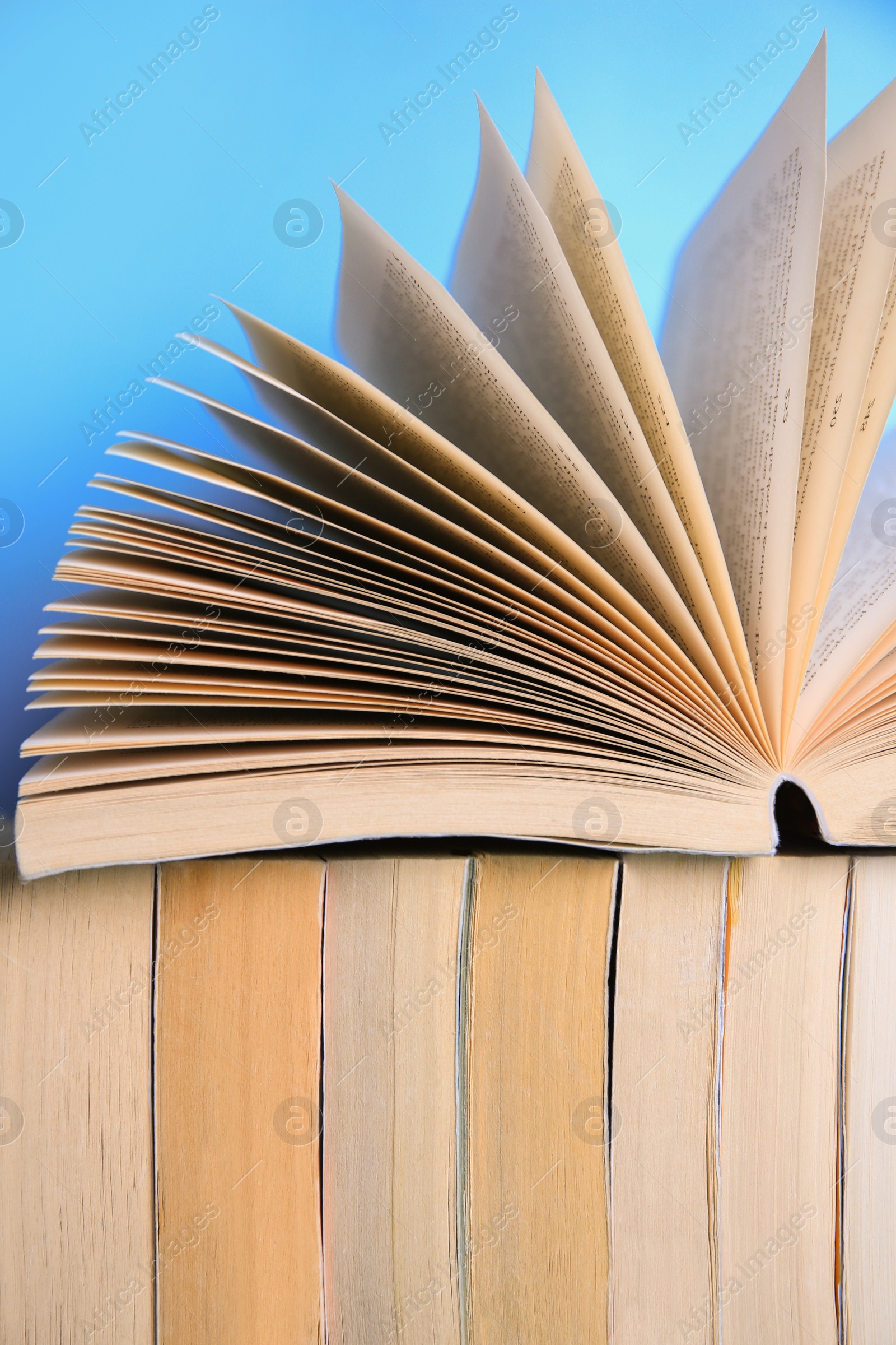 Photo of Collection of books on light blue background, closeup