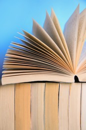 Photo of Collection of books on light blue background, closeup