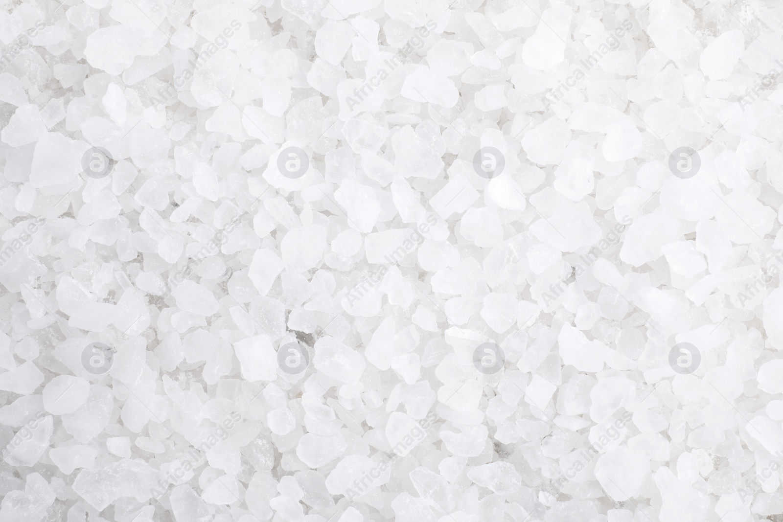 Photo of White sea salt as background, top view. Spa treatment