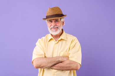 Photo of Portrait of stylish grandpa with hat on purple background