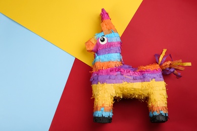 Photo of llama shaped pinata on color background, top view. Space for text