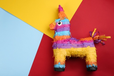 llama shaped pinata on color background, top view. Space for text