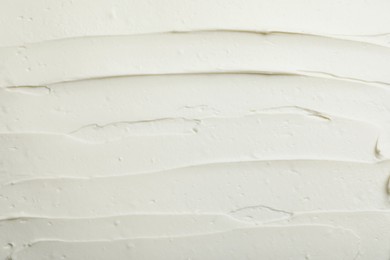 Photo of Closeup of tasty cream cheese as background, top view