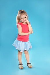 Photo of Full length portrait of cute little girl against color background