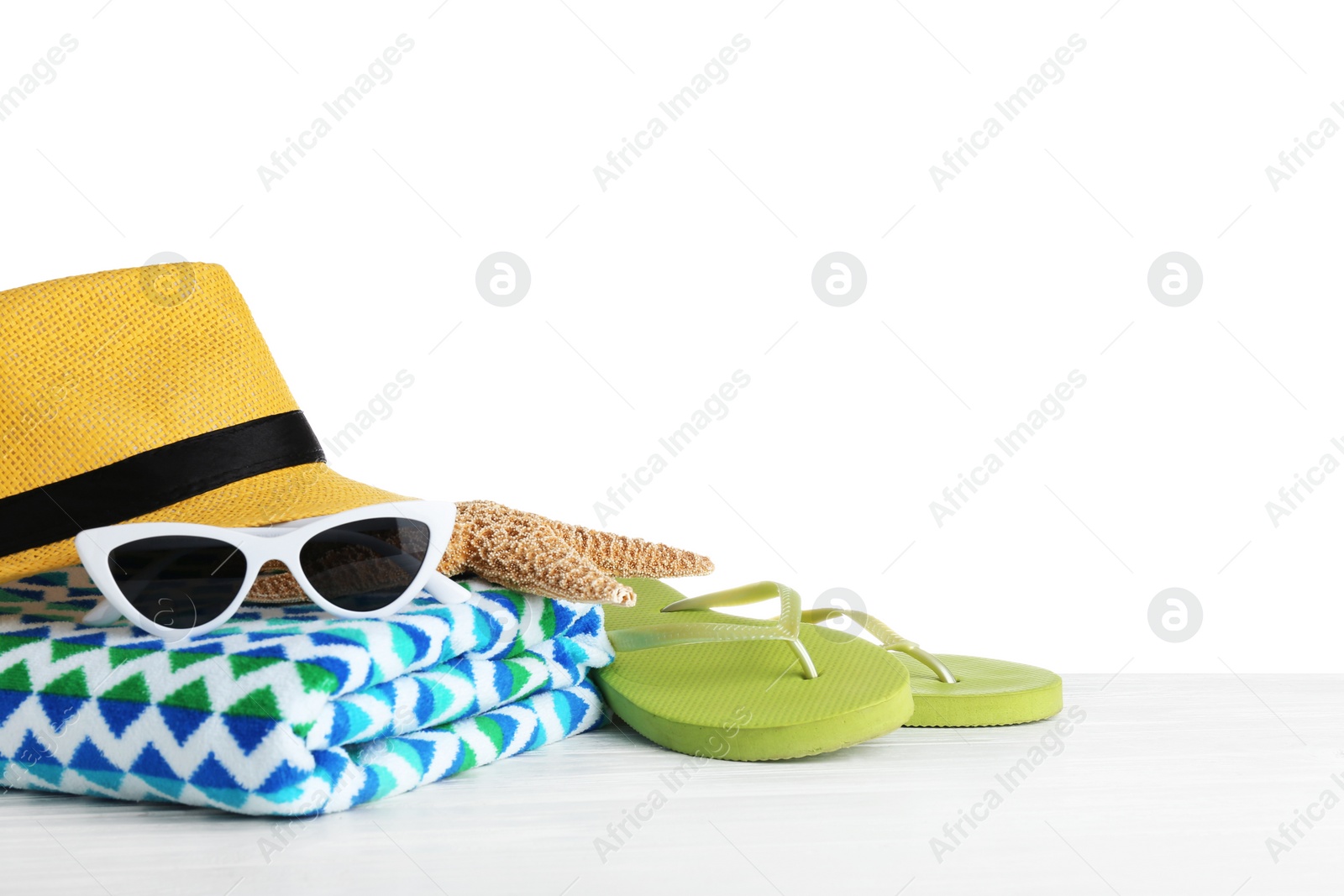 Photo of Set of beach accessories on table against white background. Space for text