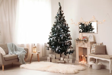 Stylish living room interior with decorated Christmas tree