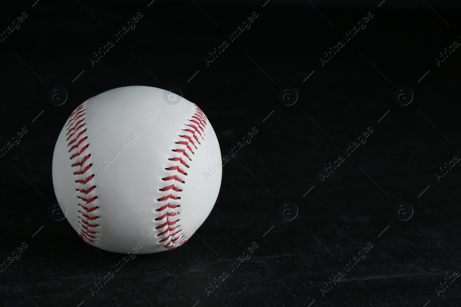 Photo of Baseball ball on black background, space for text. Sports game