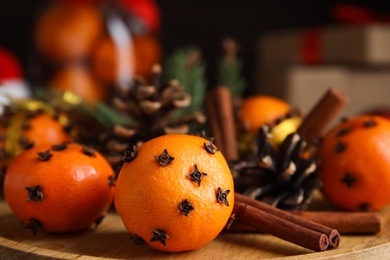 Tangerine pomander balls on wooden board, closeup