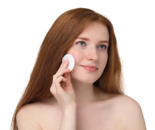 Beautiful woman with freckles wiping face on white background