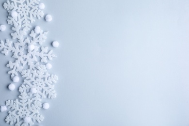 Photo of Beautiful snowflakes and decorative balls on white background, flat lay. Space for text