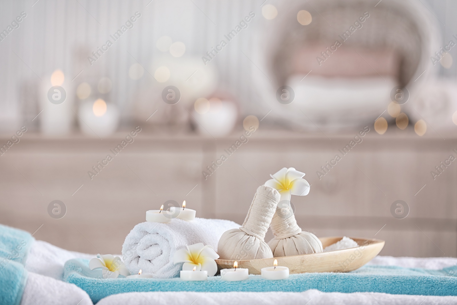 Photo of Supplies for massage on bed in modern spa salon. Place for relaxation