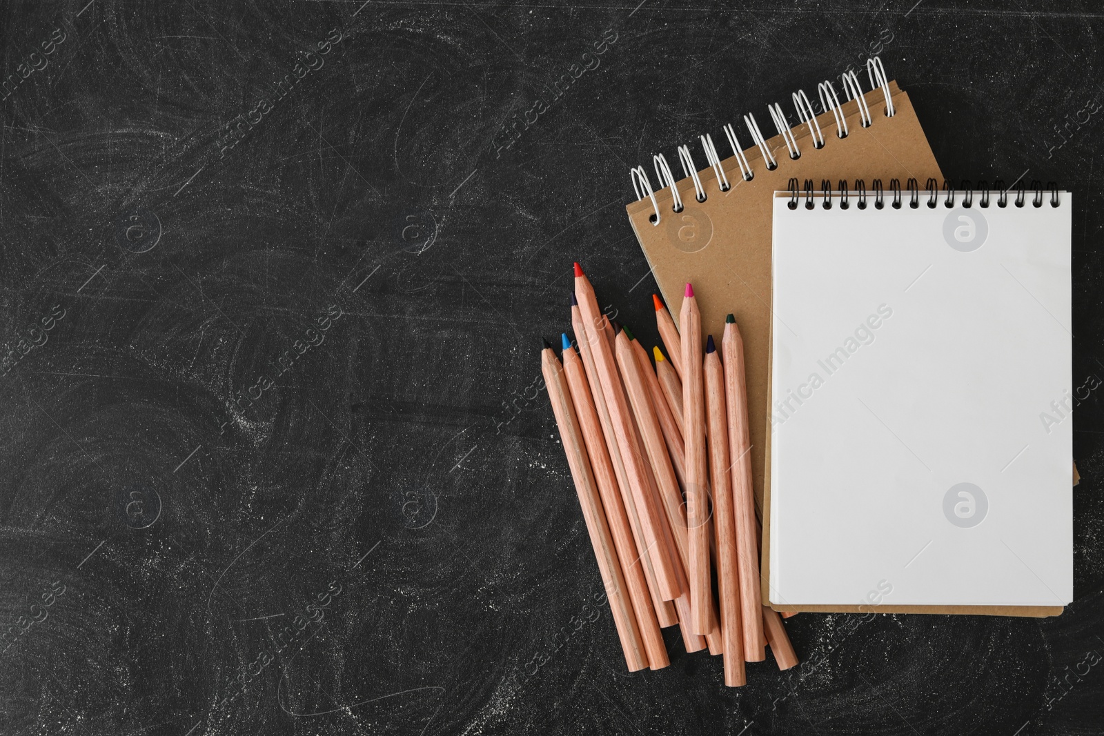 Photo of Different stationery on blackboard, flat lay with space for text. Back to school