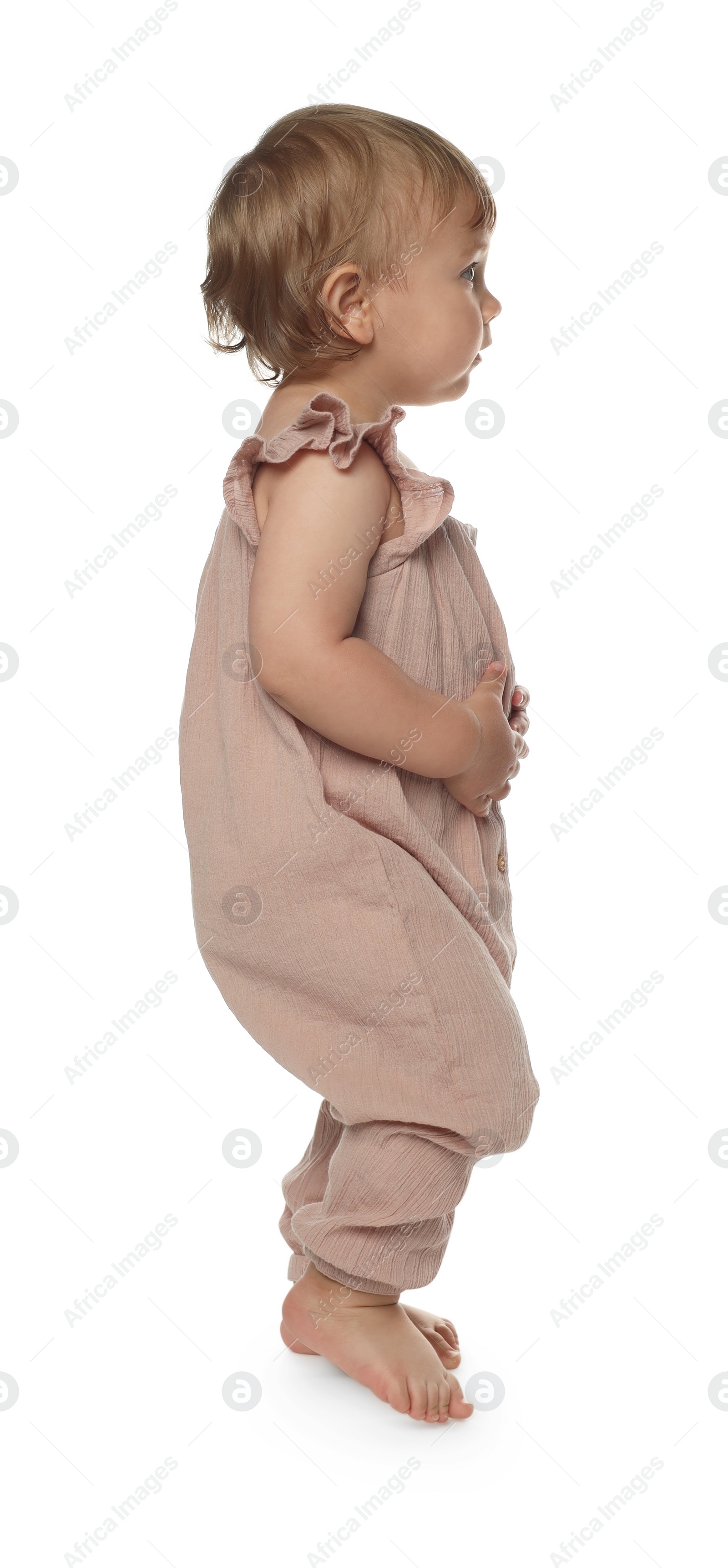 Photo of Cute baby girl learning to walk on white background