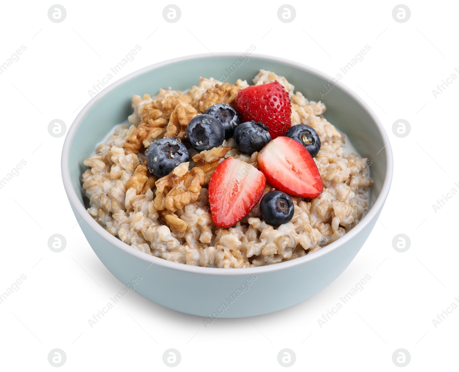 Photo of Tasty oatmeal with strawberries, blueberries and walnuts in bowl isolated on white