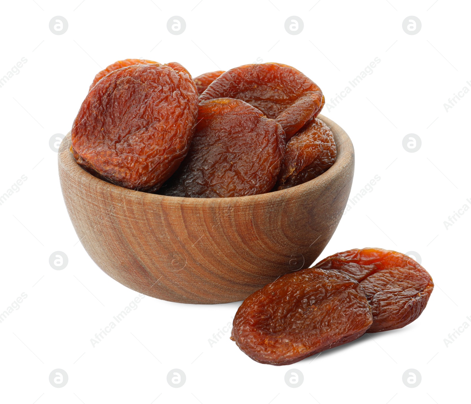 Photo of Wooden bowl with tasty dried apricots isolated on white