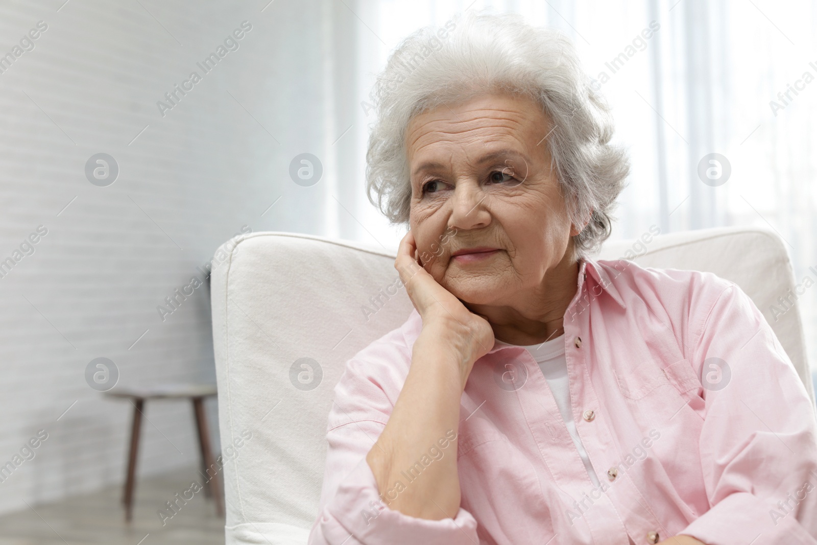 Photo of Portrait of mature woman in living room