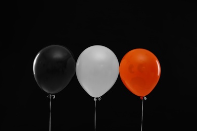 Photo of Color balloons for Halloween party on black background