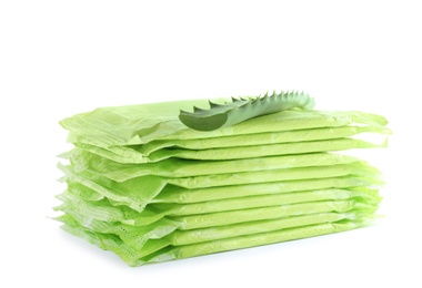 Stack of menstrual pads and aloe leaf on white background. Gynecological care