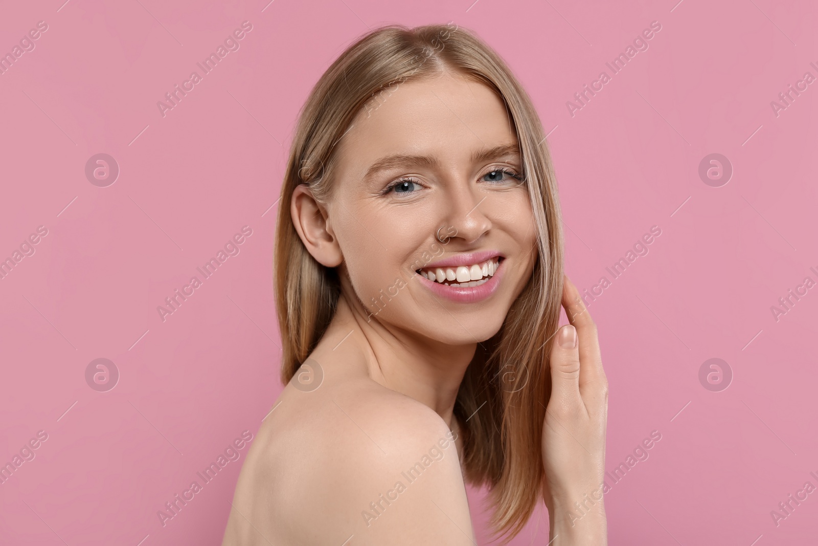 Photo of Portrait of beautiful young woman on pink background