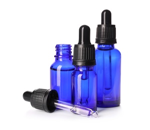 Photo of Cosmetic bottles of essential oils on white background