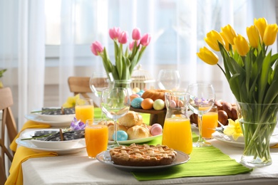 Photo of Festive Easter table setting with traditional meal at home