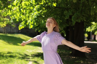 Beautiful woman in park on spring sunny day