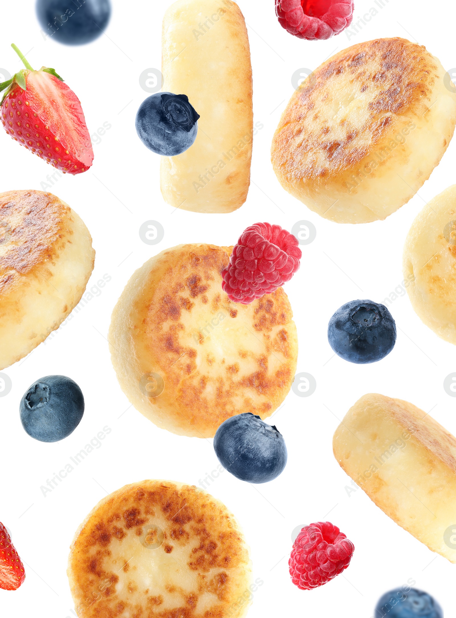 Image of Delicious cottage cheese pancakes and berries falling on white background