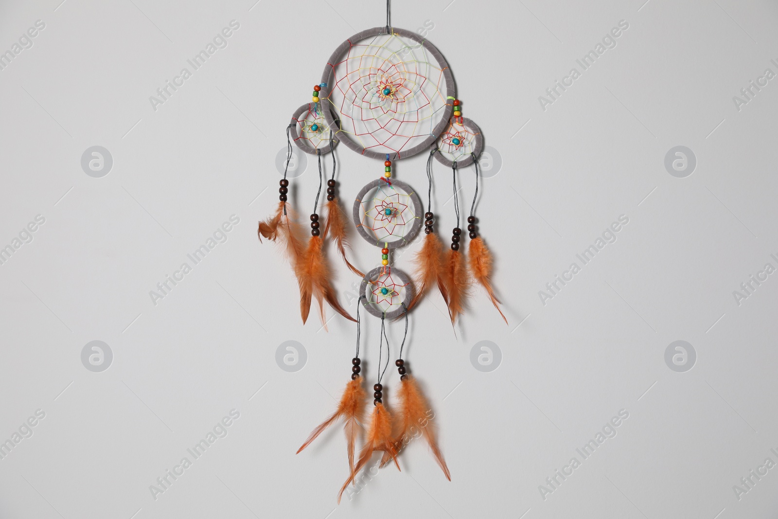 Photo of Beautiful dream catcher hanging on white wall