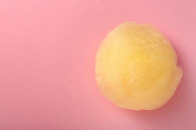 Photo of Sweet cotton candy on pink background, top view. Space for text