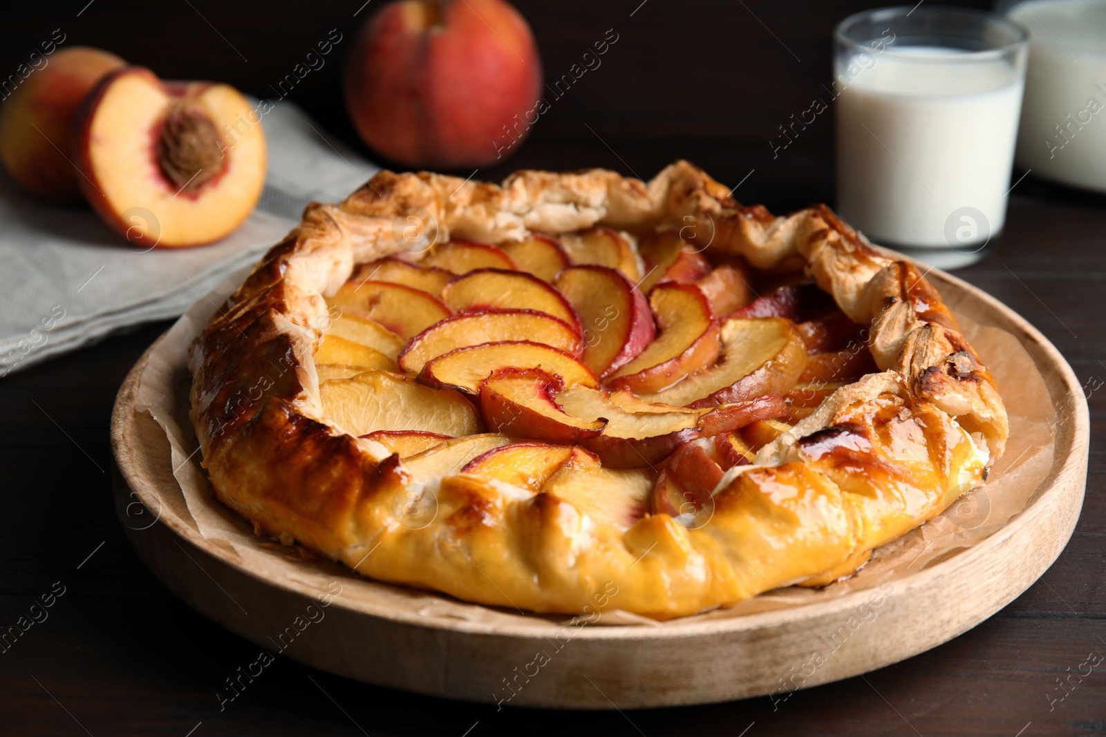 Photo of Delicious peach pie and fresh fruits on wooden table, closeup