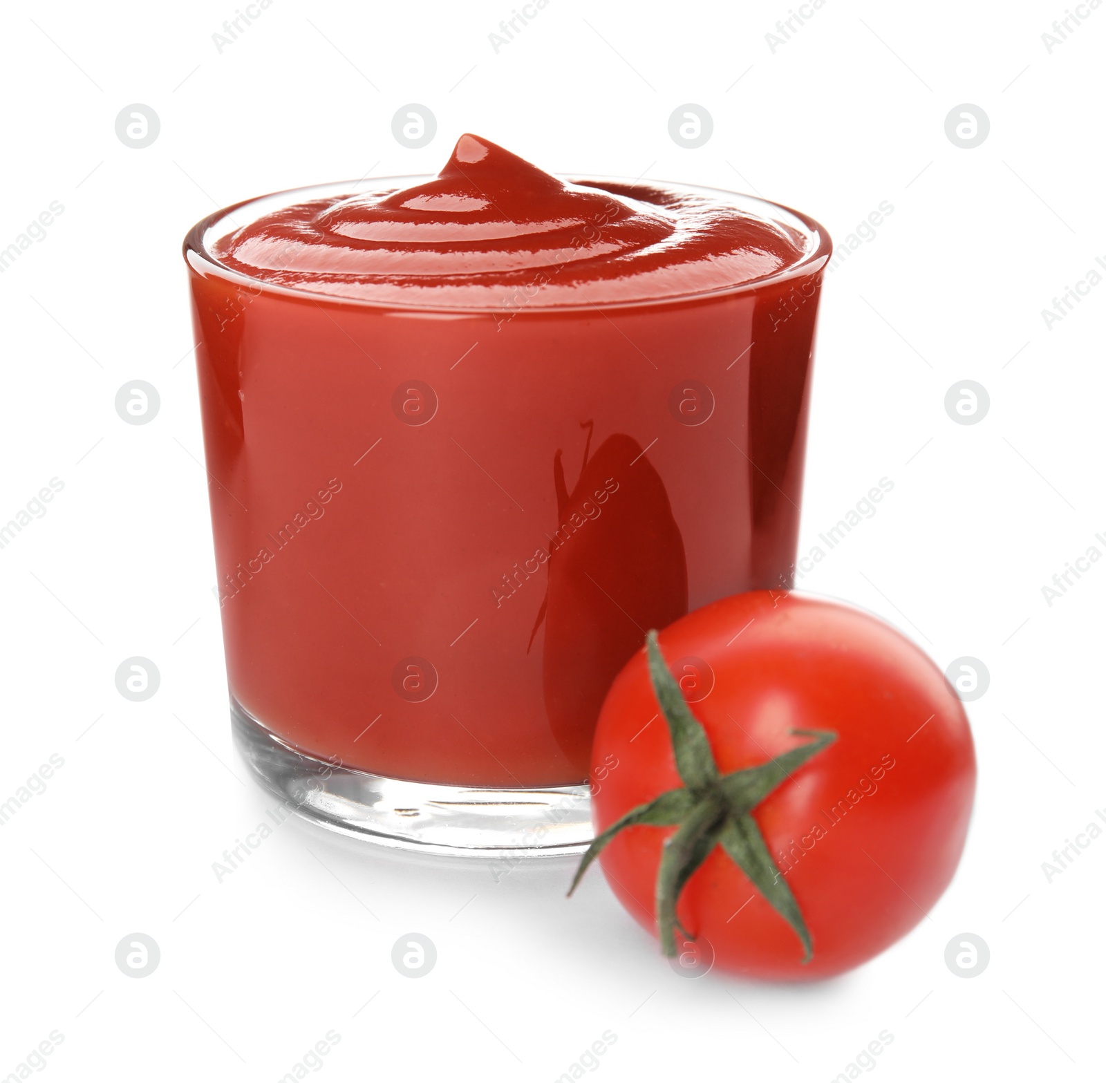 Photo of Tasty homemade tomato sauce in glass and fresh vegetable on white background