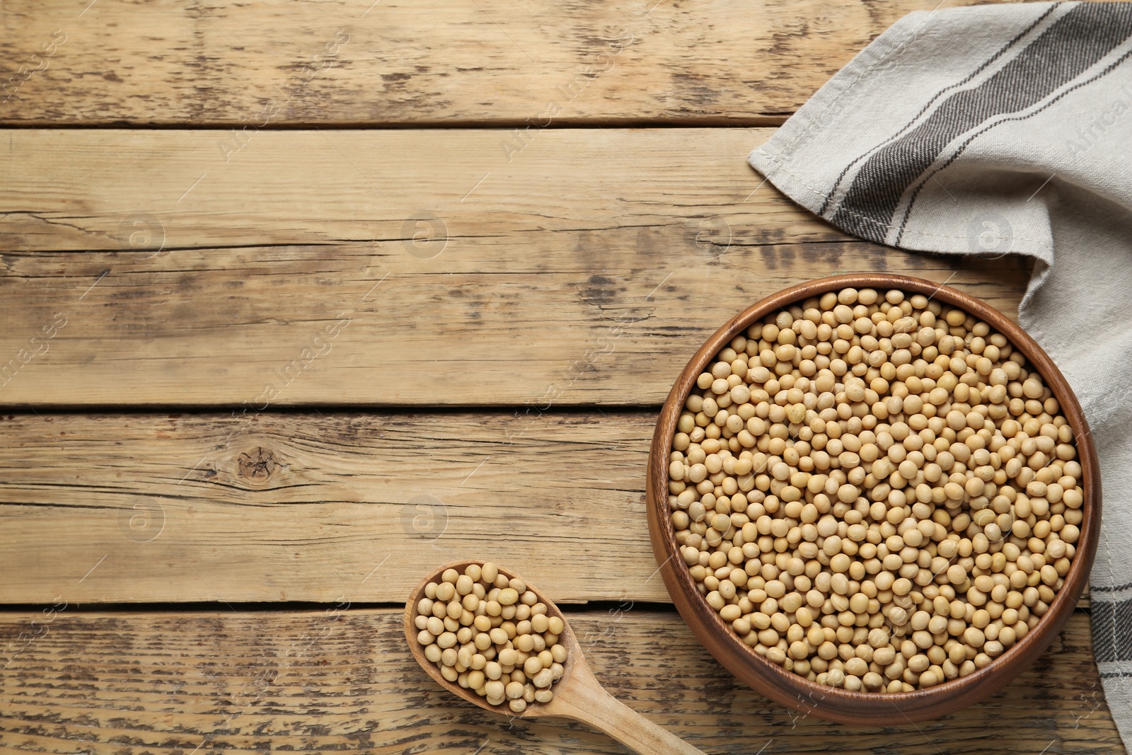 Photo of Soy on wooden table, flat lay. Space for text