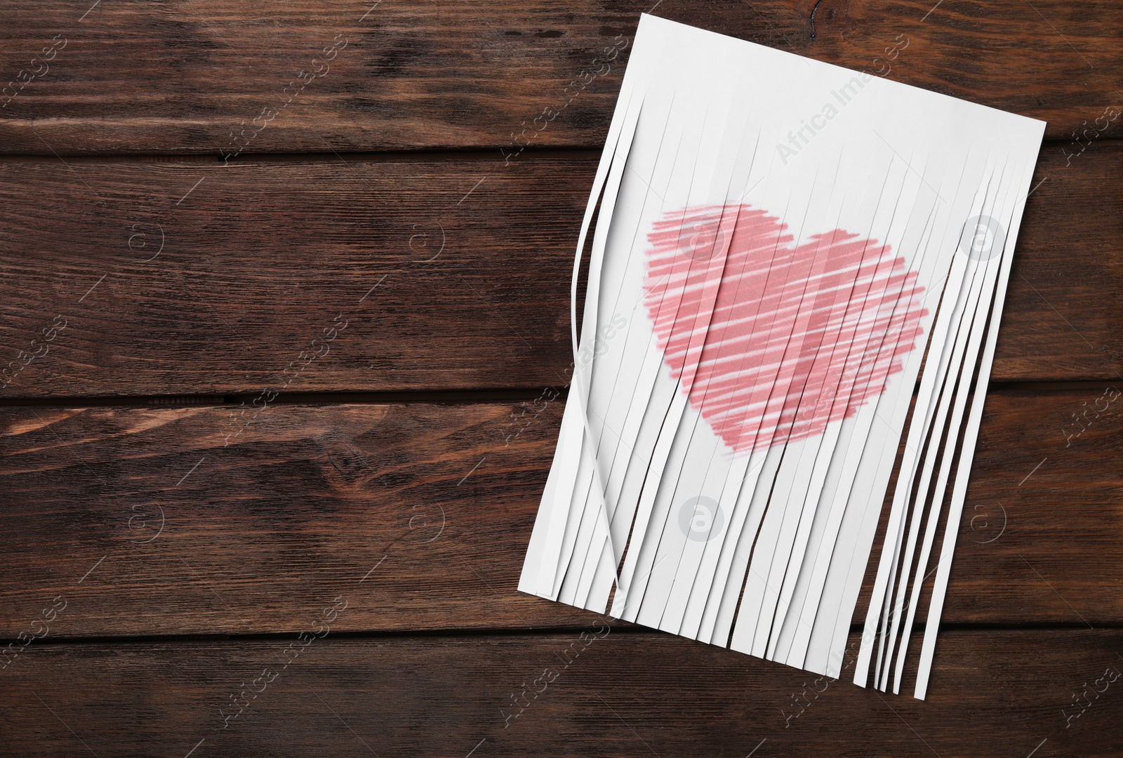 Photo of Top view of cut paper with heart drawing on wooden background, space for text. Relationship problems concept