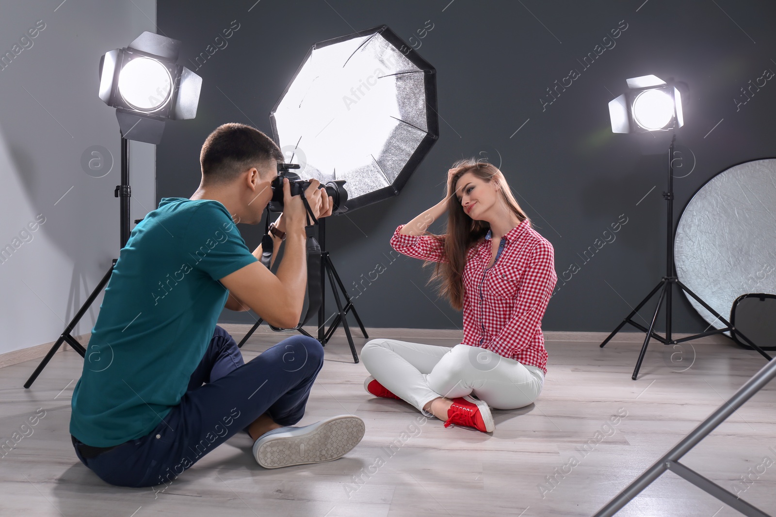 Photo of Beautiful young model posing for professional photographer in studio