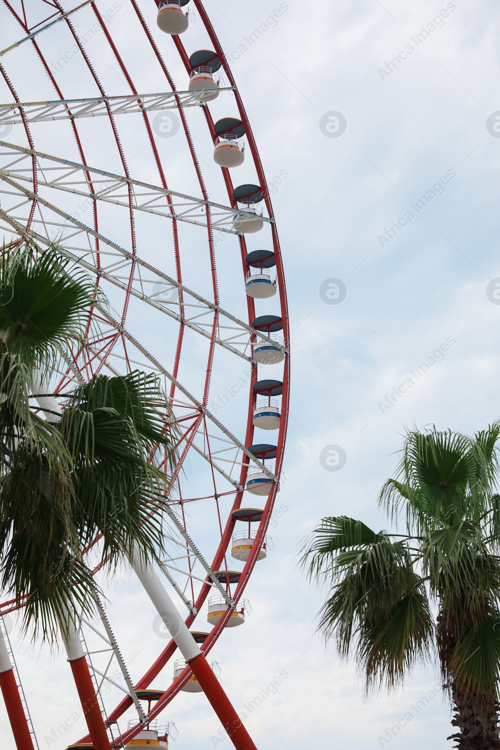 Photo of Beautiful large Ferris wheel outdoors. Amusement ride
