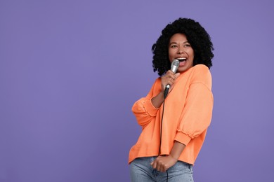 Photo of Beautiful woman with microphone singing on violet background, space for text