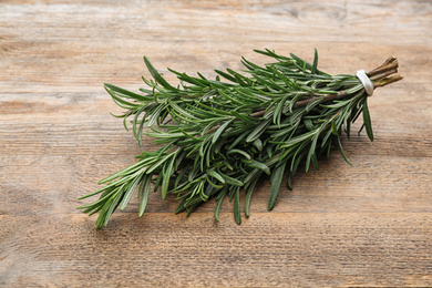 Bunch of fresh rosemary on wooden table