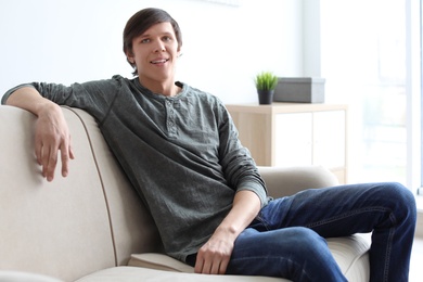 Photo of Portrait of young man on sofa