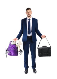 Businessman holding briefcase and backpack with toy on white background. Combining life and work