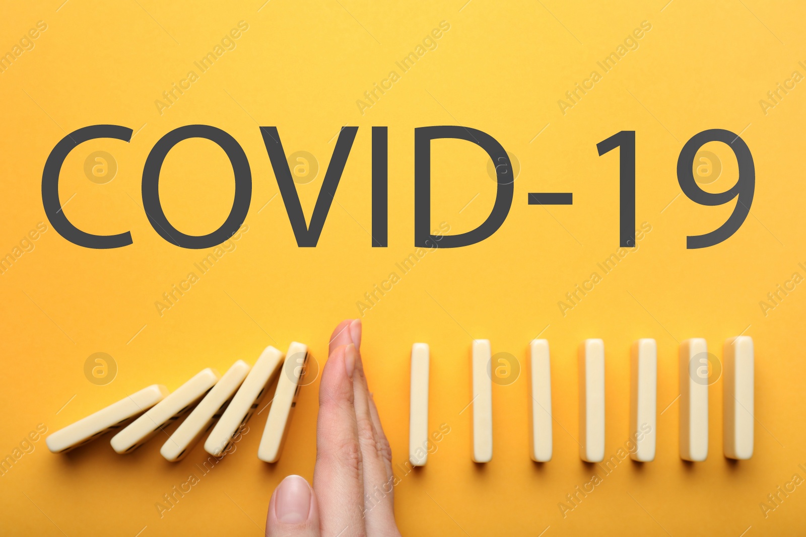Photo of Woman stopping domino effect on yellow background, top view. Prevent spreading of coronavirus