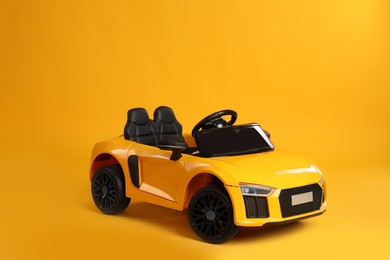 Photo of Small car on yellow background. Children's toy