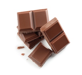 Pieces of tasty milk chocolate on white background, top view