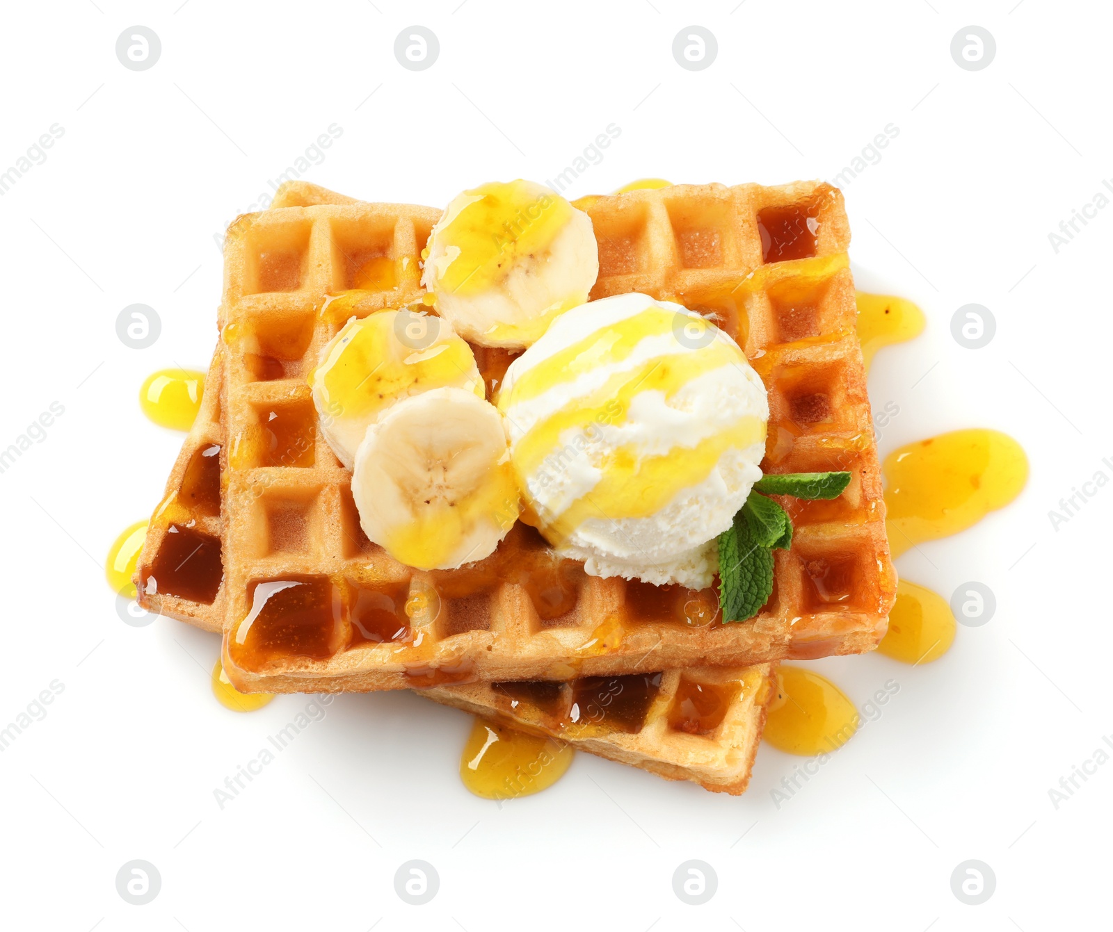 Photo of Delicious waffles with ice cream, banana and syrup on white background, top view